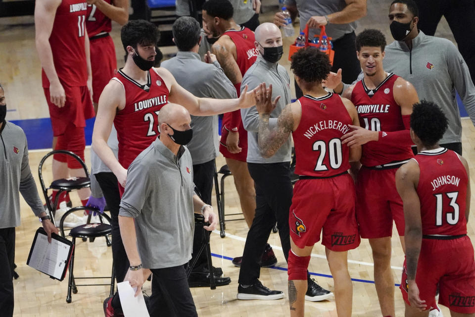 Louisville head coach Chris Mack works curtsied as his team plays against Pittsburgh during an NCAA college basketball game, Tuesday, Dec. 22, 2020, in Pittsburgh. (AP Photo/Keith Srakocic)