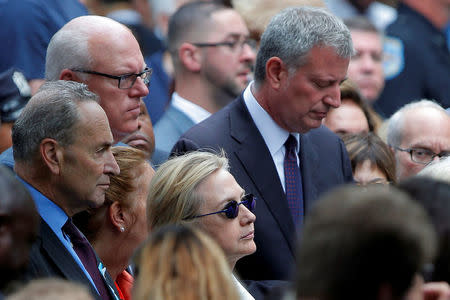 U.S. Democratic presidential candidate Hillary Clinton, New York Mayor Bill de Blasio (R) and U.S. Senator Chuck Schumer (L) attend ceremonies to mark the 15th anniversary of the September 11 attacks at the National 9/11 Memorial in New York, New York, United States September 11, 2016. REUTERS/Brian Snyder