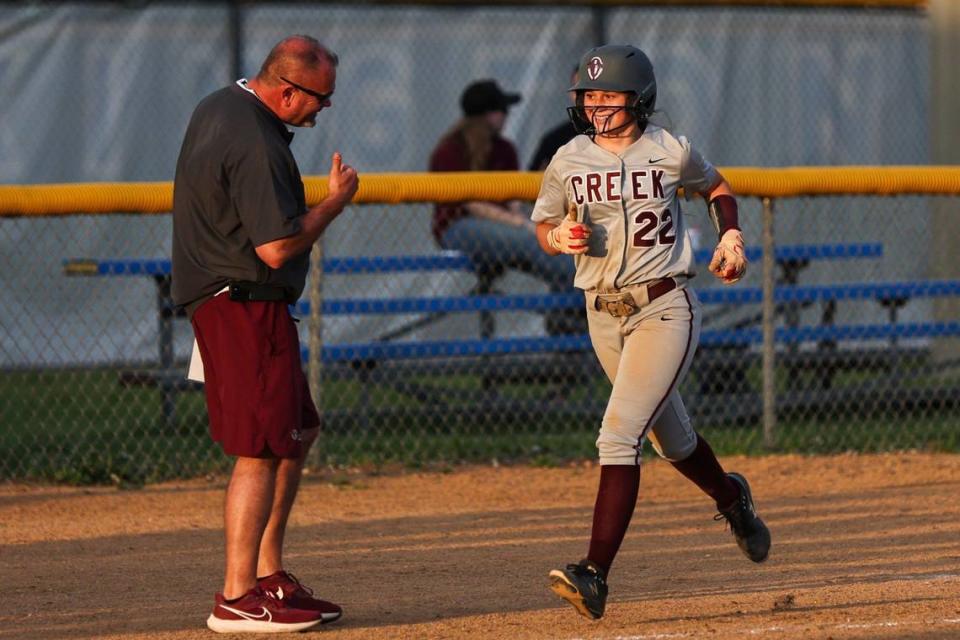 Tates Creek’s Tinley Easton (22) gets a thumbs up from head coach Michael Thomas as she complete her trot after hitting a home run in the Commodores’ 15-2 win over Lexington Christian at Lexington Christian Academy on Tuesday.