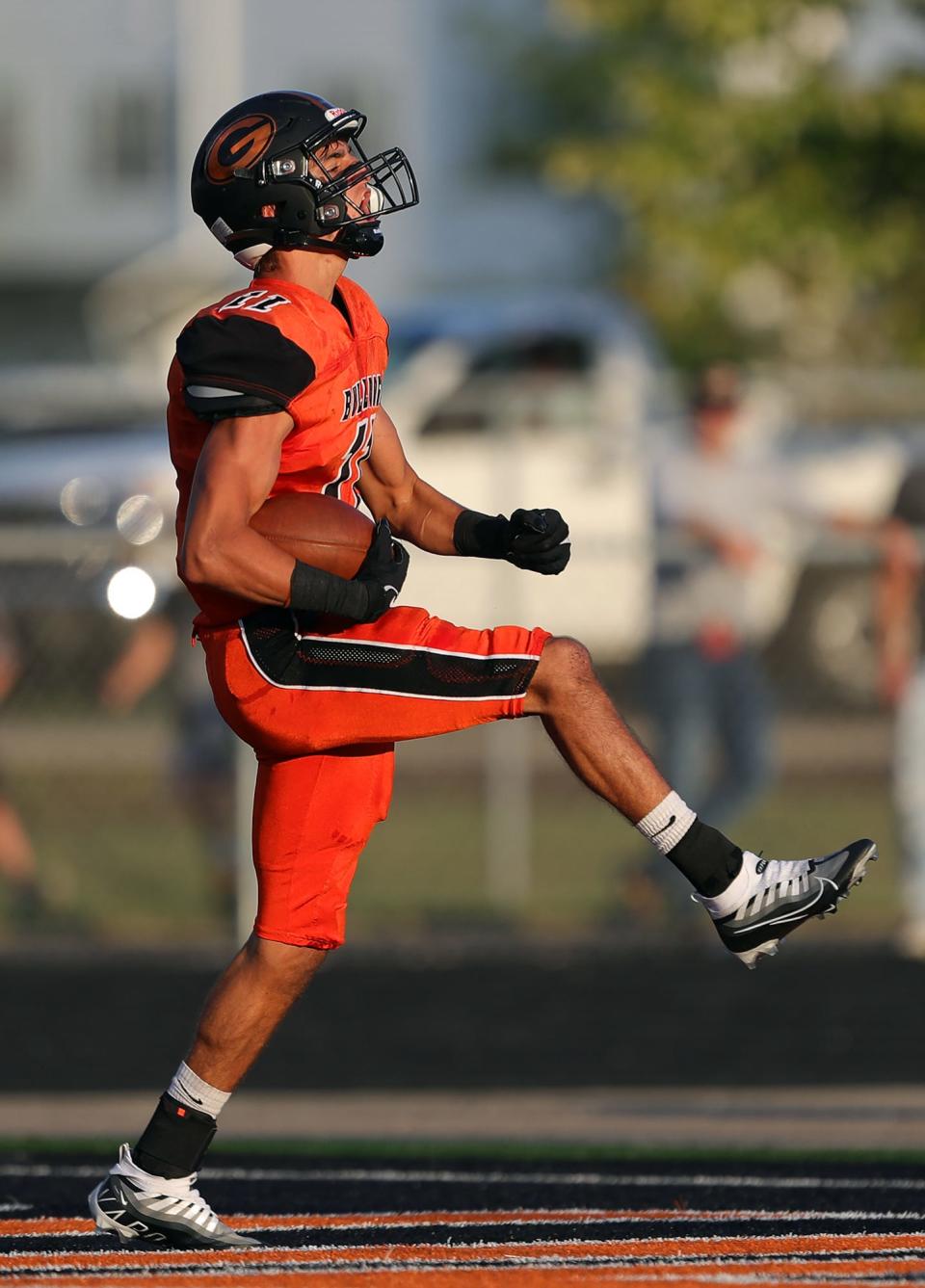 Green defensive back Samino Manson high steps into the end zone for a pick-six touchdown against the Ellet Orangemen during the first half of a high school football game, Friday, Aug. 19, 2022, in Green, Ohio.