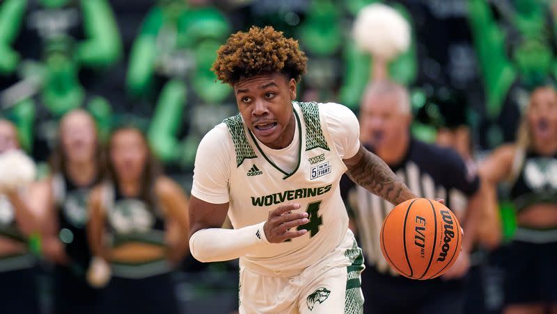 FILE — Utah Valley guard Justin Harmon brings the ball up court against BYU on Dec. 1, 2021, in Orem. Harmon scored 18 points in the Wolverines’ second-round NIT victory Colorado.
