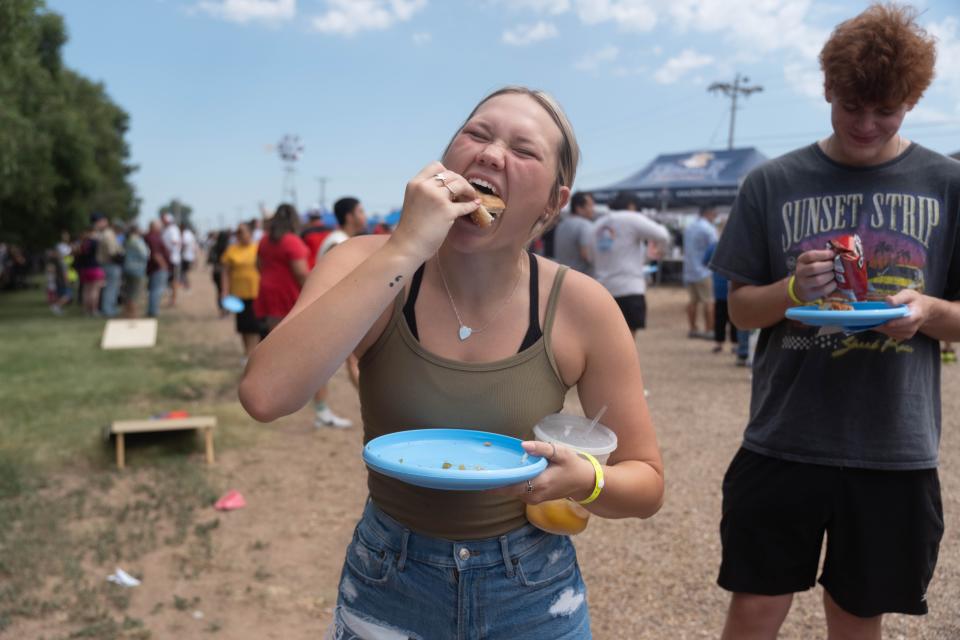 A festival goer takes a hardy bite out of her burger  Saturday at Friona's 17th annual Cheeseburger Festival.