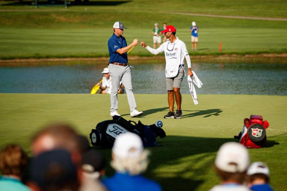 Trey Mullinax, left, fist bumps his caddie, Julien Trudeau, after winning the 2022 PGA Barbasol Championship at Keene Trace Golf Club in Nicholasville. Mullinax is not expected to be back this week to defend his title.