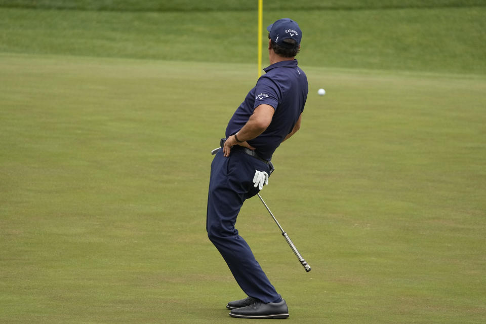 Phil Mickelson reacts to a missed birdie putt on the 16th green during the third round of the Masters golf tournament on Saturday, April 10, 2021, in Augusta, Ga. (AP Photo/Charlie Riedel)