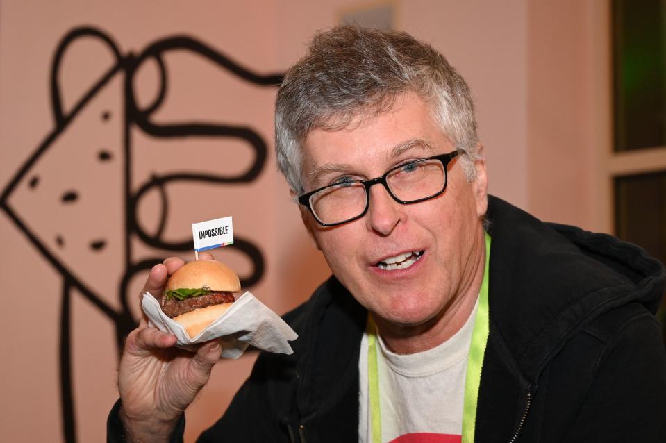 Impossible Foods CEO Pat Brown holds up an Impossible Burger 2.0, the new and improved version of the company's plant-based vegan burger that tastes like real beef, at a press event during CES 2019 in Las Vegas, Nevada on January 7, 2019. - The updated version can be cooked on a grill and has a better flavor and lowered cholesterol, fat and calories than the original.  "Unlike the cow, we get better at making meat every single day," CEO of Impossible Foods CEO Pat Brown. (Photo by Robyn Beck / AFP)        (Photo credit should read ROBYN BECK/AFP via Getty Images)