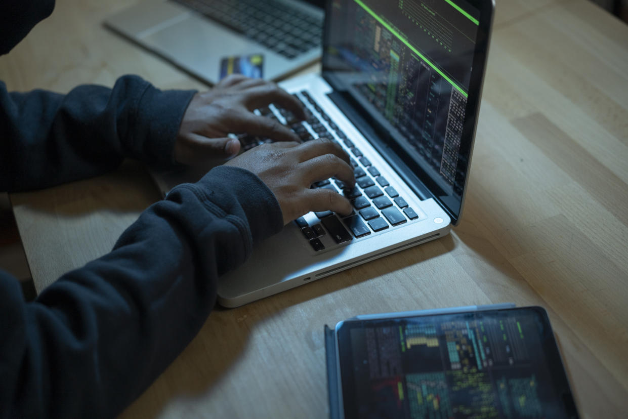 Close up of hands typing on laptop. (PHOTO: Getty Images)