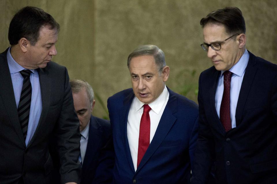 Israeli Prime Minister Benjamin Netanyahu, center, arrives to the weekly cabinet meeting at his office in Jerusalem, Israel, Sunday, Jan. 29, 2017. (Abir Sultan, Pool via AP)