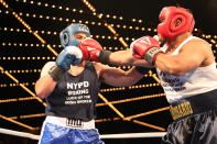 <p>Carlos Del Rosario leans with a punch in the ring against Josue Torres in the NYPD Boxing Championships at the Theater at Madison Square Garden on June 8, 2017. (Photo: Gordon Donovan/Yahoo News) </p>