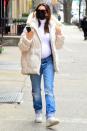 <p>Emily Ratajkowski shows off her growing baby bump in a white turtleneck and jeans on Wednesday in N.Y.C.</p>