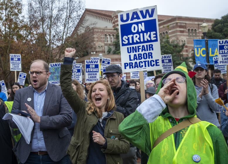 LOS ANGELES, CA-DECEMBER 2, 2022: Graeme Blair, left, an associate professor of political science at UCLA and Anna Markowitz, 2nd from left, an assistant professor of education at UCLA, show their support for graduate student workers at UCLA on strike, calling for university to offer the students a contract with a dramatic increase in pay and benefits to match the skyrocketing cost of living in California. (Mel Melcon / Los Angeles Times)