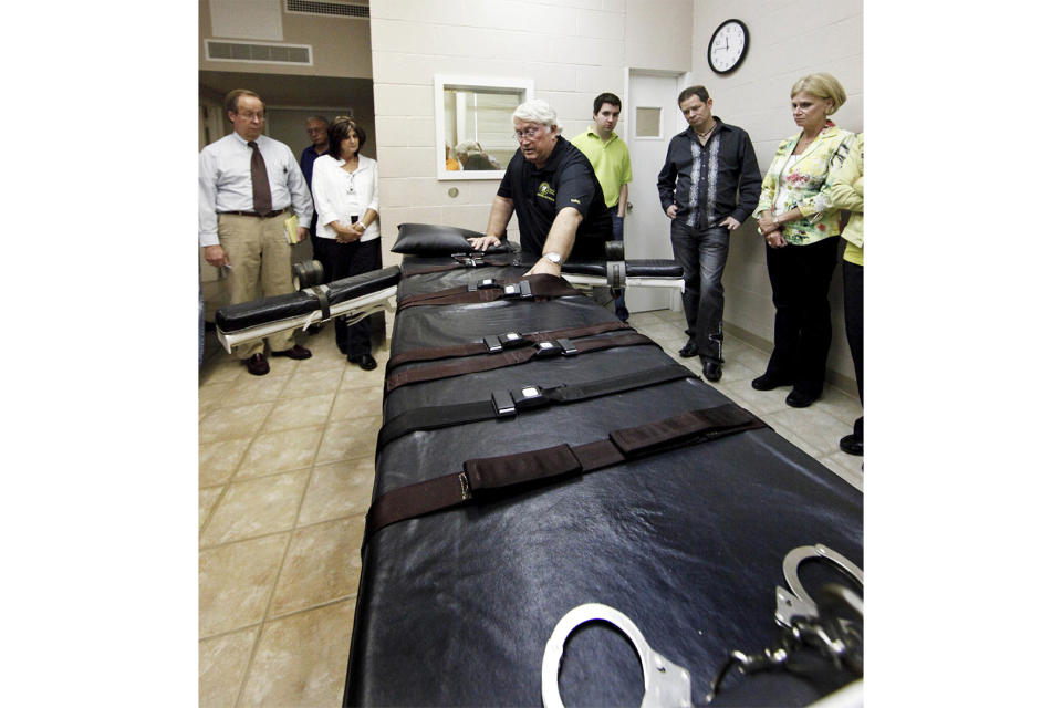 FILE - Louisiana State Penitentiary Warden Burl Cain discusses the gurney used for lethal injections, Sept. 18, 2009, at the Louisiana State Penitentiary in Angola, La. In Louisiana, around 60 people currently sit on death row, but an execution hasn't occurred since 2010. Between a conservative governor and a new execution method, there has been a renewed push to find alternatives to lethal injection. (AP Photo/Judi Bottoni, File)