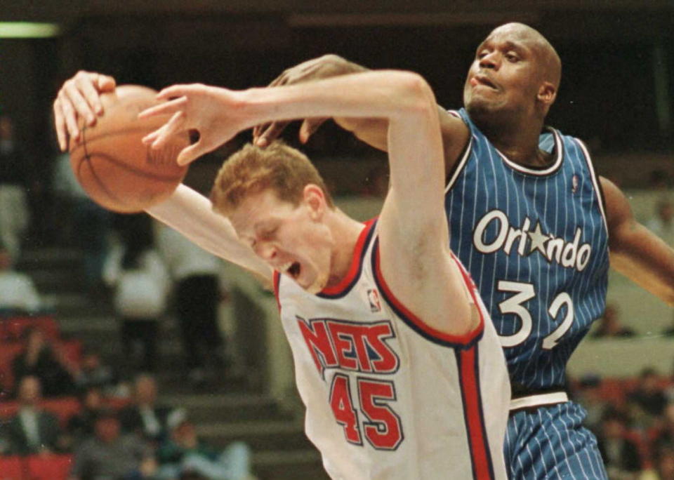 New Jersey Nets' Shawn Bradley gets the ball slapped from his hands by Orlando Magic's center Shaquille O'Neal in the second half of their match in East Rutherford, New Jerset. (MARK D. PHILLIPS/AFP/Getty Images)