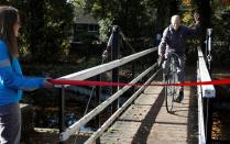 82 year old cyclist Russ Mantle celebrates after cycling his millionth mile during a ride in Mytchett, near Aldershot