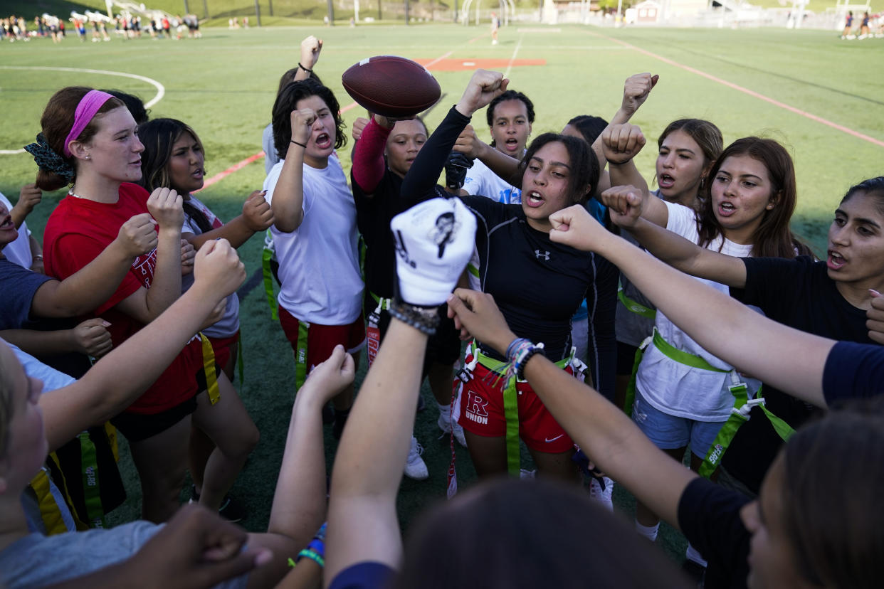 FILE - Elsa Morin, 17, center right, leads a chant as Redondo Union High School girls try out for a flag football team on Thursday, Sept. 1, 2022, in Redondo Beach, Calif. California officials are expected to vote Friday on the proposal to make flag football a girls' high school sport for the 2023-24 school year. (AP Photo/Ashley Landis, File)