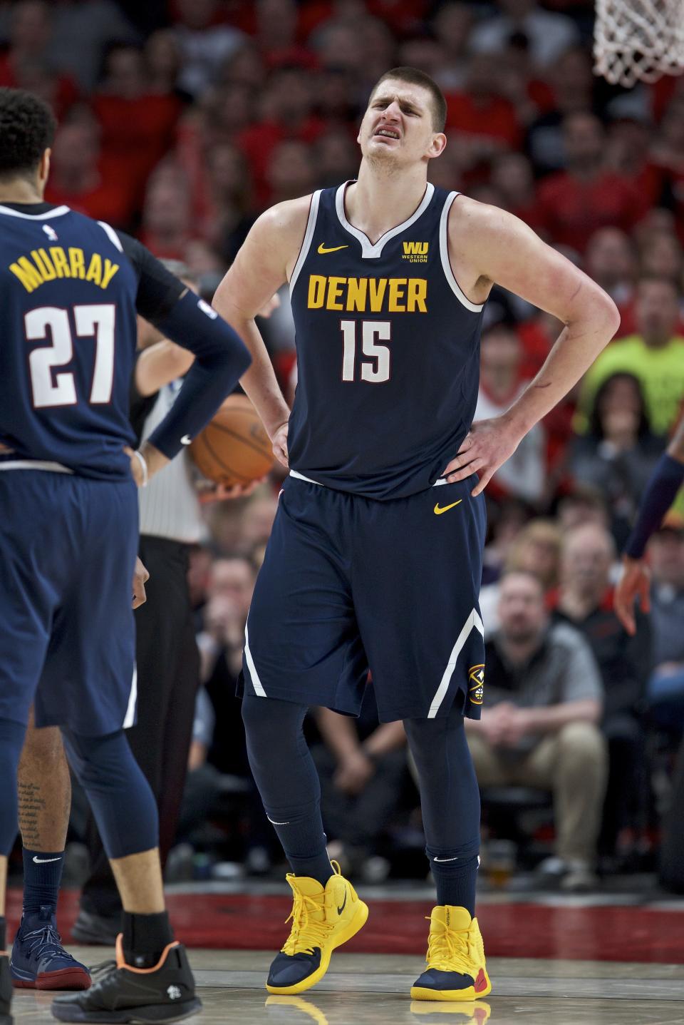 Denver Nuggets center Nikola Jokic grimaces as he walks off the court against the Portland Trail Blazers during the first half of Game 4 of an NBA basketball second-round playoff series, Sunday, May 5, 2019, in Portland, Ore. The Nuggets won 116-112. (AP Photo/Craig Mitchelldyer)