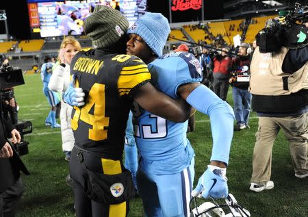 Nov 16, 2017; Pittsburgh, PA, USA; Pittsburgh Steelers wide receiver Antonio Brown (84) and Tennessee Titans cornerback Brice McCain embrace following the Steelers 40-17 win at Heinz Field. Mandatory Credit: Philip G. Pavely-USA TODAY Sports