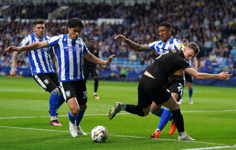 Sheffield Wednesday&#x002019;s Reece James (left) and Liam Palmer battle for the ball with Peterborough United&#x002019;s Jack Taylor during the Sky Bet League One play-off semi-final second leg match at Hillsborough, Sheffield