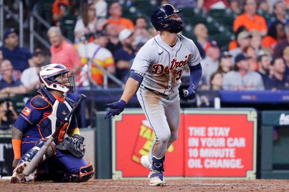 Detroit Tigers center fielder Riley Greene, right, flips his bat as he watches his home run in front of Houston Astros catcher Martin Maldonado, left, during the seventh inning at Minute Maid Park in Houston on Monday, April 3, 2023.