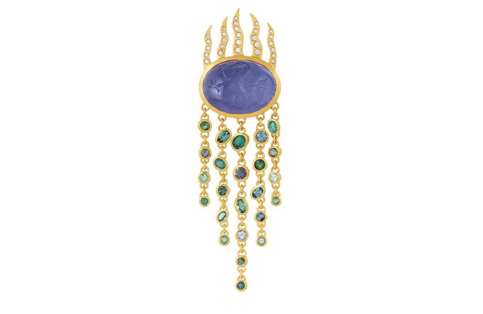 On the Fire and Water Brooch, an engraved chalcedony of 30.1 carats is surrounded by diamonds and Paraiba tourmalines set in 18-karat yellow gold; $17,500, at dalehernsdorf.com