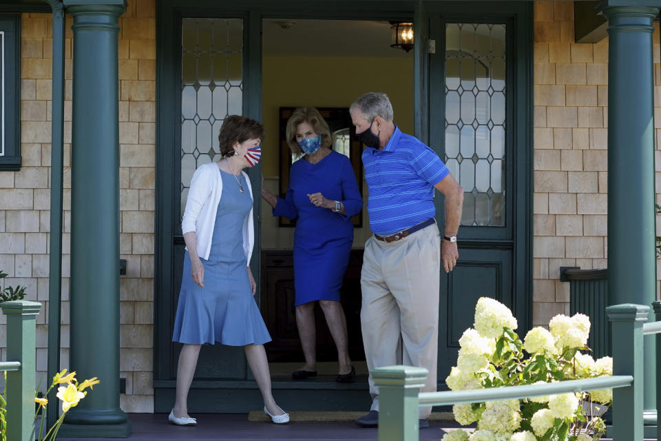 Former President George W. Bush holds the door for Sen. Susan Collins, R-Maine, and his wife Laura Bush after having lunch at their home, Friday, Aug. 21, 2020, in Kennebunkport, Maine. George W. Bush on Friday backed Collins in his first public endorsement of the 2020 election cycle. (AP Photo/Mary Schwalm)