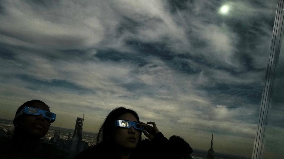 <div>People look toward the sky at the 'Edge at Hudson Yards' observation deck during a total solar eclipse across North America, in New York City on April 8, 2024. This year's path of totality is 115 miles (185 kilometers) wide and home to nearly 32 million Americans, with an additional 150 million living less than 200 miles from the strip. The next total solar eclipse that can be seen from a large part of North America won't come around until 2044. (Photo by Charly TRIBALLEAU / AFP) (Photo by CHARLY TRIBALLEAU/AFP via Getty Images)</div>