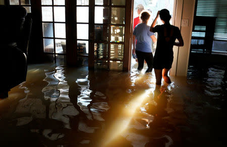 A family that wanted to remain anonymous moves belongings from their home flooded by Harvey in Houston, Texas August 31, 2017. REUTERS/Rick Wilking