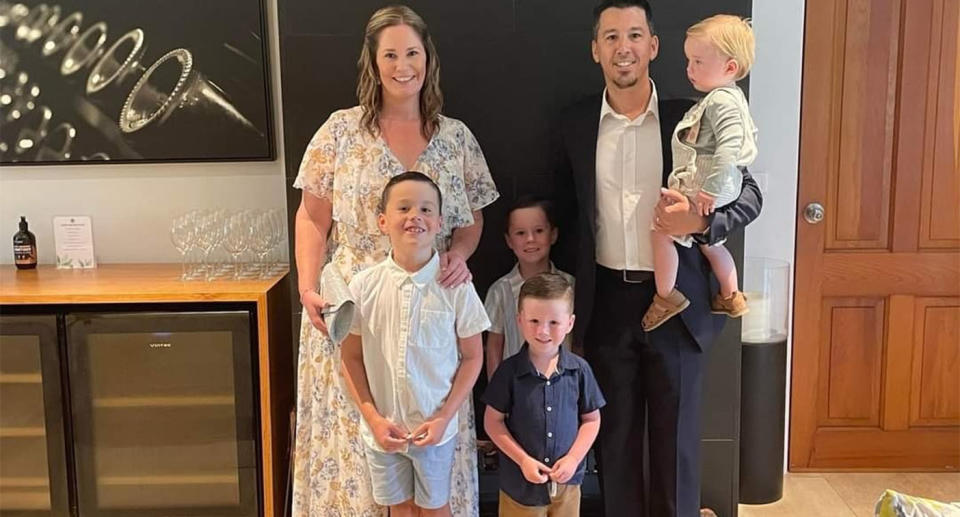 The Thompson family smile for a photo dressed in formal clothes.