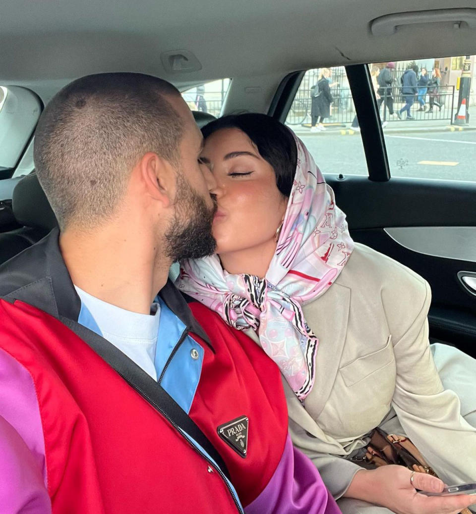 Martha and Michael share a kiss in the back of a taxi