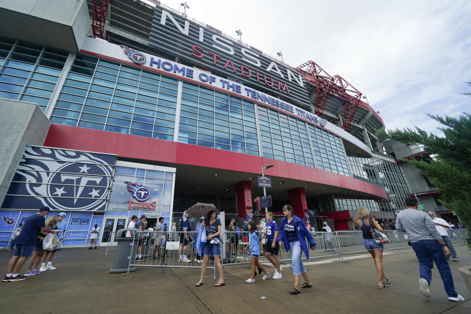 FILE - Fans arrive at Nissan Stadium before an NFL football game between the Tennessee Titans and the New York Giants, Sunday, Sept. 11, 2022, in Nashville, Tenn. The Titans will be moving to a new stadium for the 2027 season, and they're taking the current name with them under a new 20-year naming rights deal with Nissan North America, the team announced Friday, Nov. 17, 2023. (AP Photo/Mark Humphrey, File)