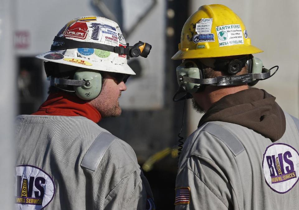 In this March 25, 2014 photo, workers talk during a hydraulic fracturing operation at an Encana Corp. well pad near Mead, Colo. Hydraulic fracturing, or “fracking,” can greatly increase the productivity of an oil or gas well by splitting open rock with water and/or sand pumped underground at high pressure. (AP Photo/Brennan Linsley) (AP Photo/Brennan Linsley)