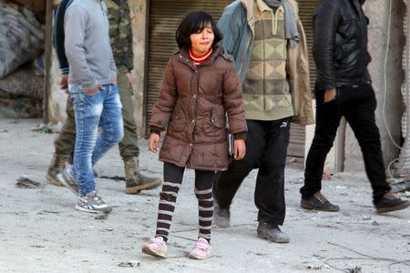 A girl mourns the loss of her relatives after airstrikes by pro-Syrian government forces in the rebel held al-Saleheen neighborhood of Aleppo, Syria February 8, 2016. REUTERS/Abdalrhman Ismail