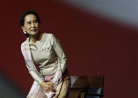 Myanmar's opposition leader Aung San Suu Kyi takes her seat as she waits to speak to the Myanmar community living in Singapore on the island of Sentosa in Singapore September 22, 2013. REUTERS/Edgar Su