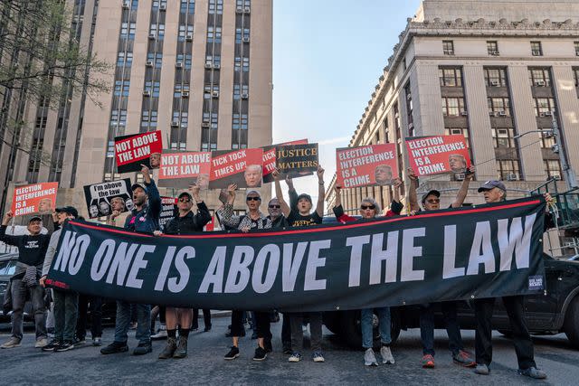 <p>ADAM GRAY/AFP via Getty</p> Protesters of Donald Trump appear outside the Manhattan criminal court on April 15, 2024