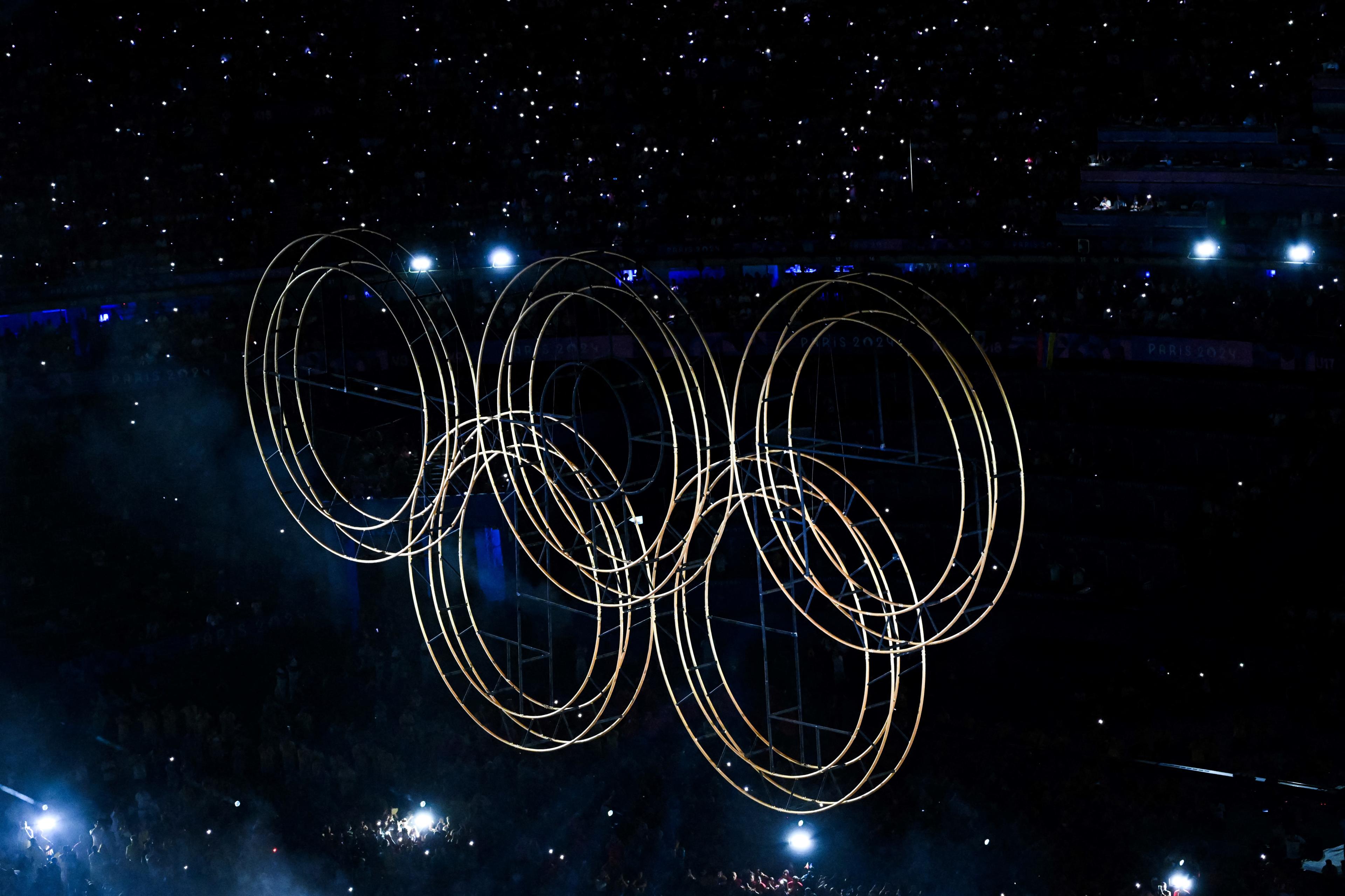 TOPSHOT - An overview shows the Olympic rings during the closing ceremony of the Paris 2024 Olympic Games at the Stade de France in Saint-Denis on the outskirts of Paris on August 11, 2024. (Photo by Julie SEBADELHA / AFP) (Photo by JULIE SEBADELHA/AFP via Getty Images)