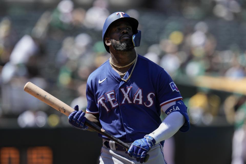 Texas Rangers' Adolis García walks to the dugout after striking out against the Oakland Athletics during the ninth inning of a baseball game Wednesday, Aug. 9, 2023, in Oakland, Calif. (AP Photo/Godofredo A. Vásquez)