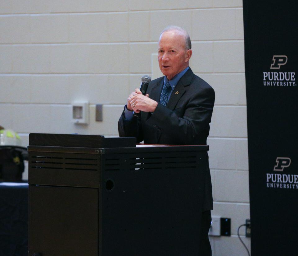 Outgoing Purdue University president, Mitch Daniels, speaks about the history of Purdue University Fire Department Retired Fire Chief, Kevin Ply, during changing of the guard ceremony, on Wednesday, Dec. 14, 2022, in Lafayette, Ind.
