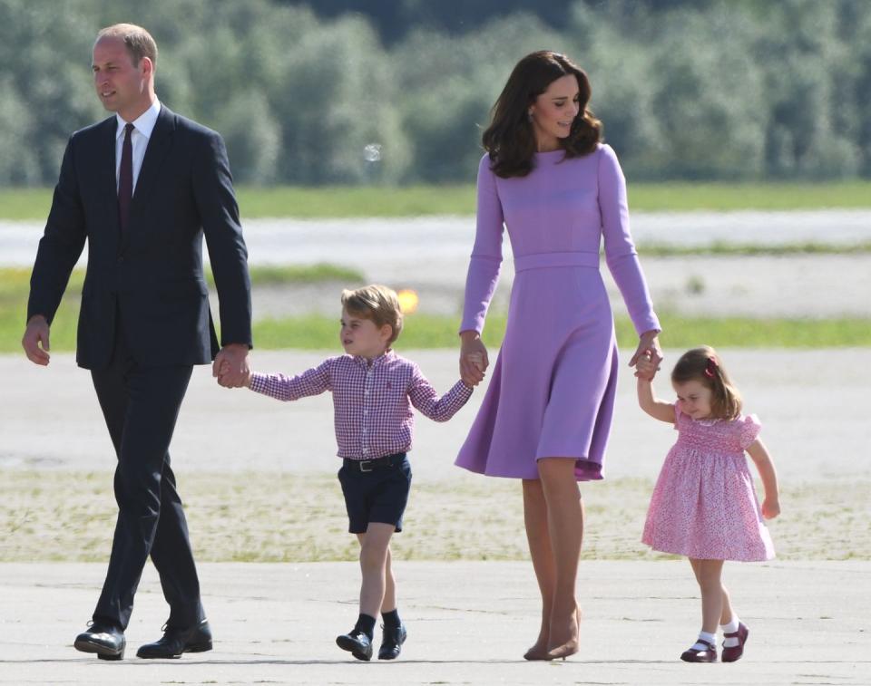 <p>The Duke and Duchess held hands with their young children, Prince George and Princess Charlotte, during a royal tour of Germany. The young family is color coordinated in bright hues as they board an aircraft in Hamburg. </p>