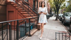 Young woman walking in the city street.