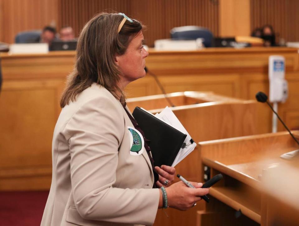 Laura Reynolds, founding and managing member of Hold the Line Coalition, attempts to speak against the expansion but was sent back to her seat during a meeting discussing a vote on expanding the Urban Development Boundary before the Miami-Dade County Commission on Thursday, May 19, 2022.