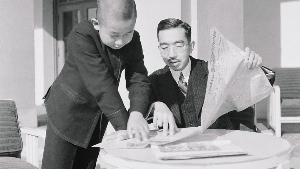 emperor hirohito and prince akihito reading a newspaper