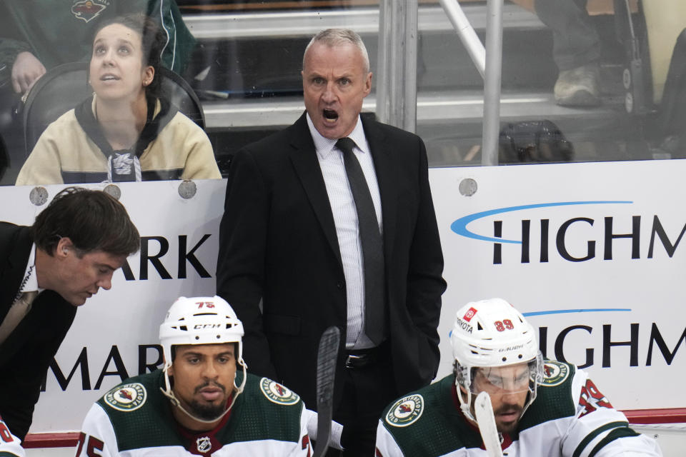Minnesota Wild head coach Dean Evason, center, gives instructions during the first period of an NHL hockey game against the Pittsburgh Penguins in Pittsburgh, Thursday, April 6, 2023. (AP Photo/Gene J. Puskar)