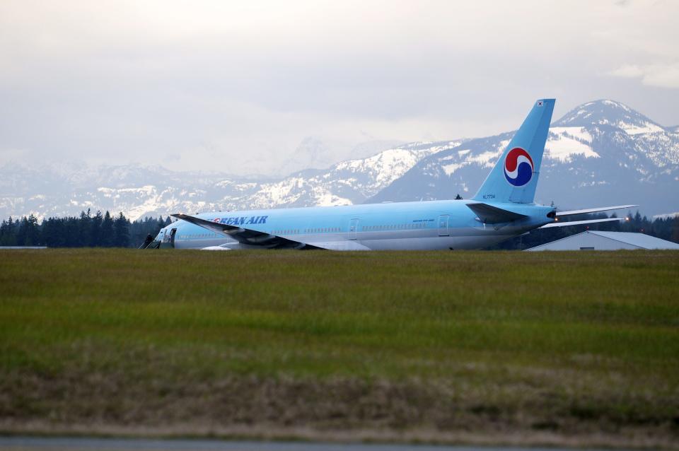 A Korean Air Boeing 777 is parked on the runway of a Canadian Forces base in Comox, British Columbia after an emergency landing on Tuesday April 10, 2012. The plane, en route from Vancouver, British Columbia to Seoul, diverted to Comox on Vancouver Island under escort by two U.S. fighter jets after the airline's U.S. call center received a call about a threat on board. (AP Photo/The Canadian Press, Richard Warrington)