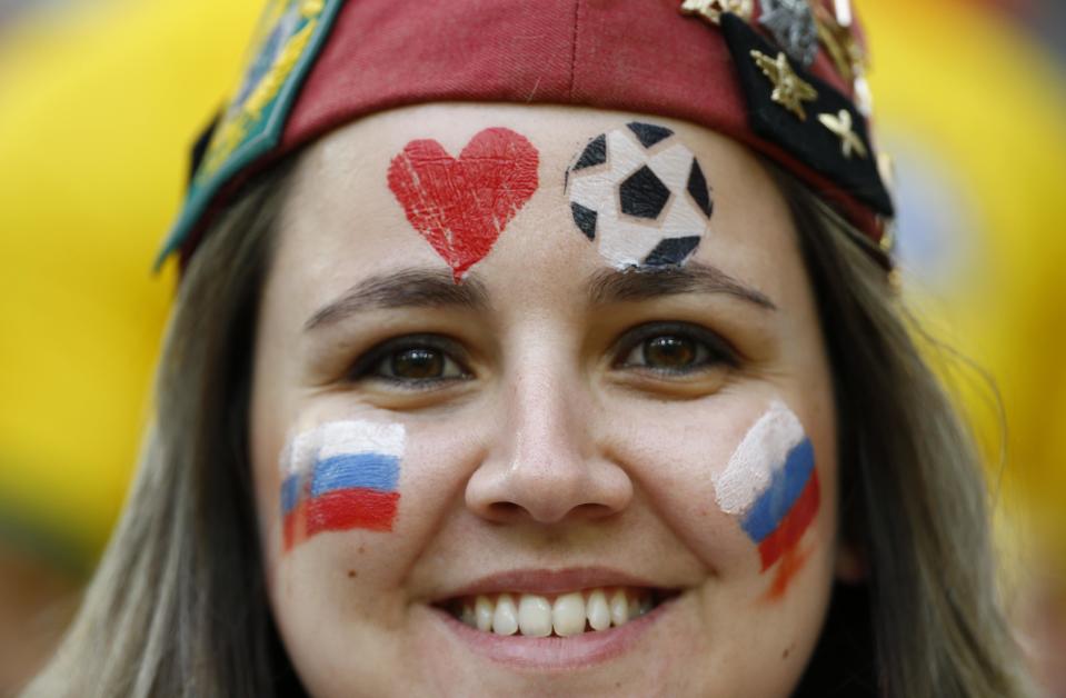 A Russian fan poses before the start of the 2014 World Cup Group H soccer match against Algeria at the Baixada arena in Curitiba