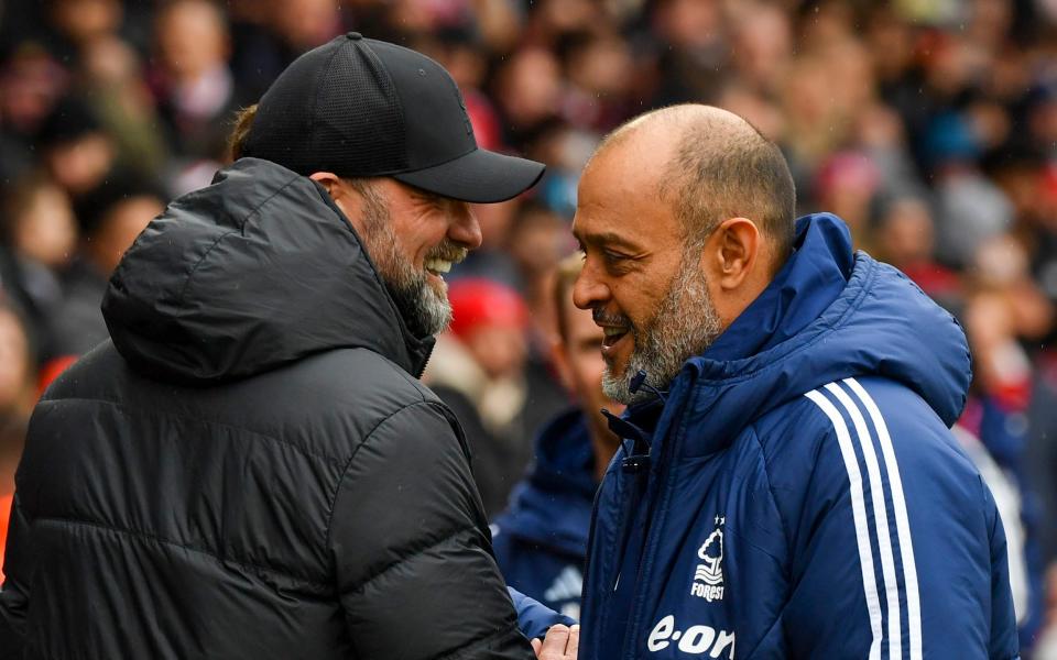 Liverpool's manager Jurgen Klopp, left, speaks with Nottingham Forest's head coach Nuno Espirito Santo