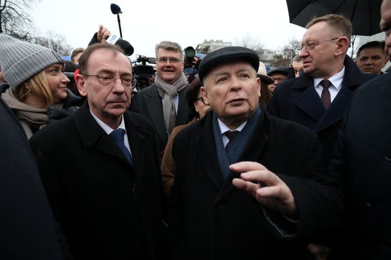 Former Interior Kaminski and his deputy Wasik with PiS leader Kaczynski stand outside parliament building in Warsaw