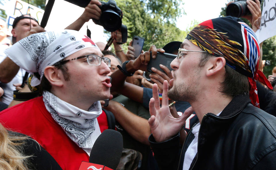 <p>A counter-protester and "Free Speech Rally" attendee face off in the crowd.</p>