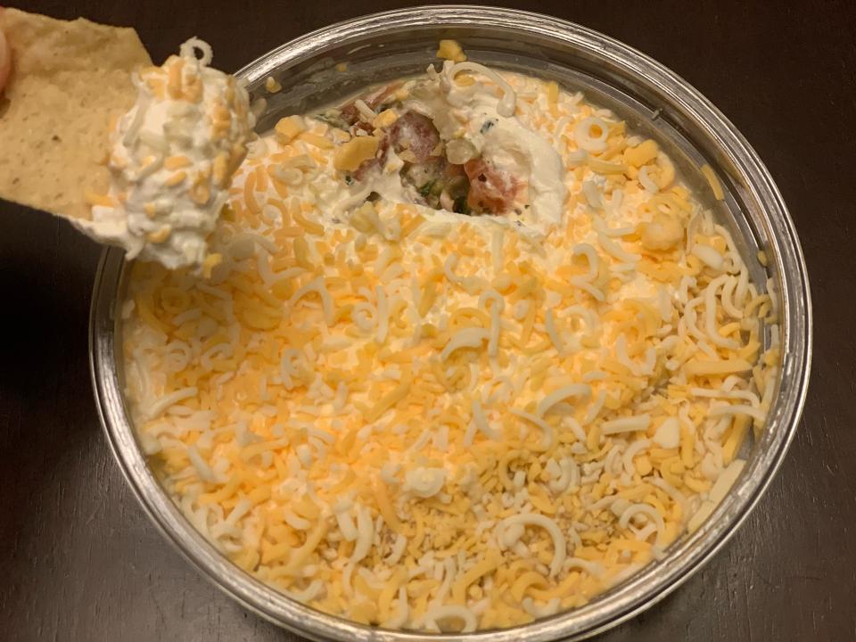 chip dipping into trader joe's five layer dip