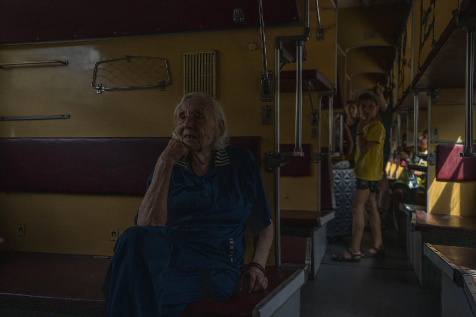 Ninety-one-year-old internally displaced woman from Sloviansk, who was a Russian language teacher, Iraida Vorobiova, sits on the train at the Pokrovsk train station heading to Dnipro, Donetsk region, eastern Ukraine, Wednesday, July 6, 2022. Many are responding to the authorities' pleas to evacuate. As Russian troops march west, a steady flow of people continue to evacuate from towns caught in the crosshairs of the war, with hundreds leaving on a daily evacuation train from Pokrovsk. (AP Photo/Nariman El-Mofty)
