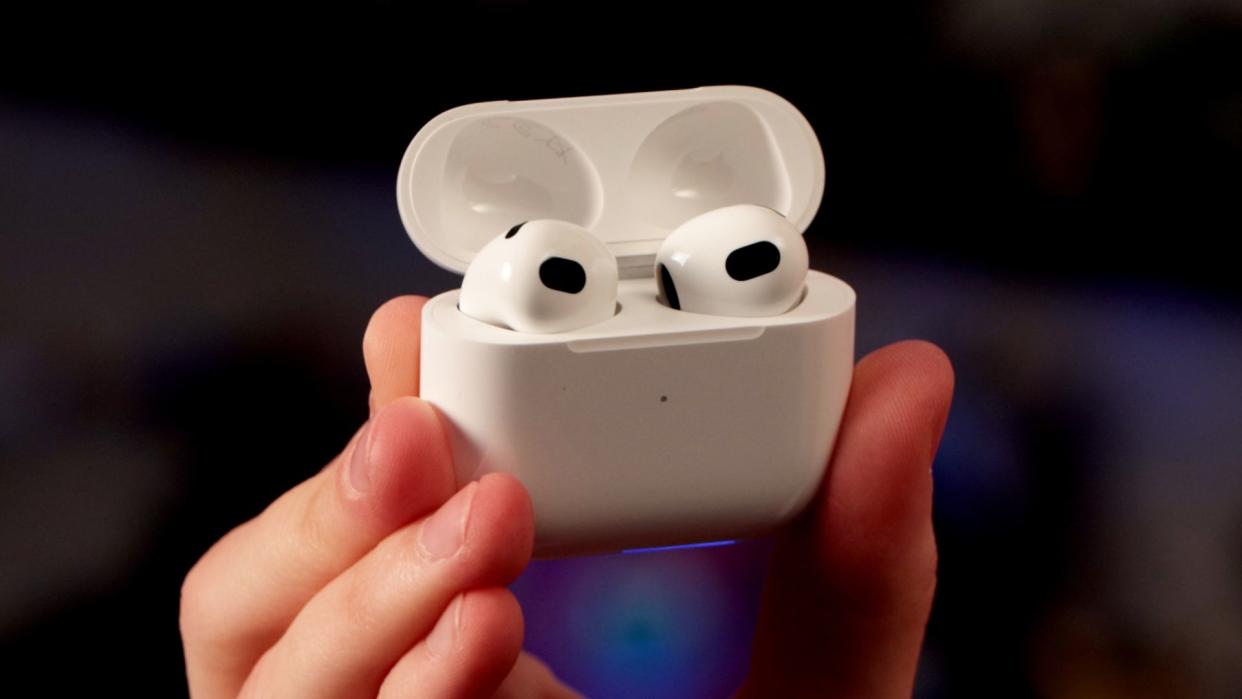  Apple AirPods 3rd Gen held in hand. 