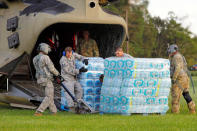 U.S. Army personnel unload food and water from a CH-47 Chinook helicopter delivering the needed supplies to a community isolated by the effects of Hurricane Florence, now downgraded to a tropical depression, in Atkinson, North Carolina, U.S., September 18, 2018. REUTERS/Jonathan Drake